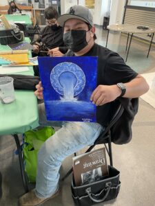 An art apprentice showing his work.